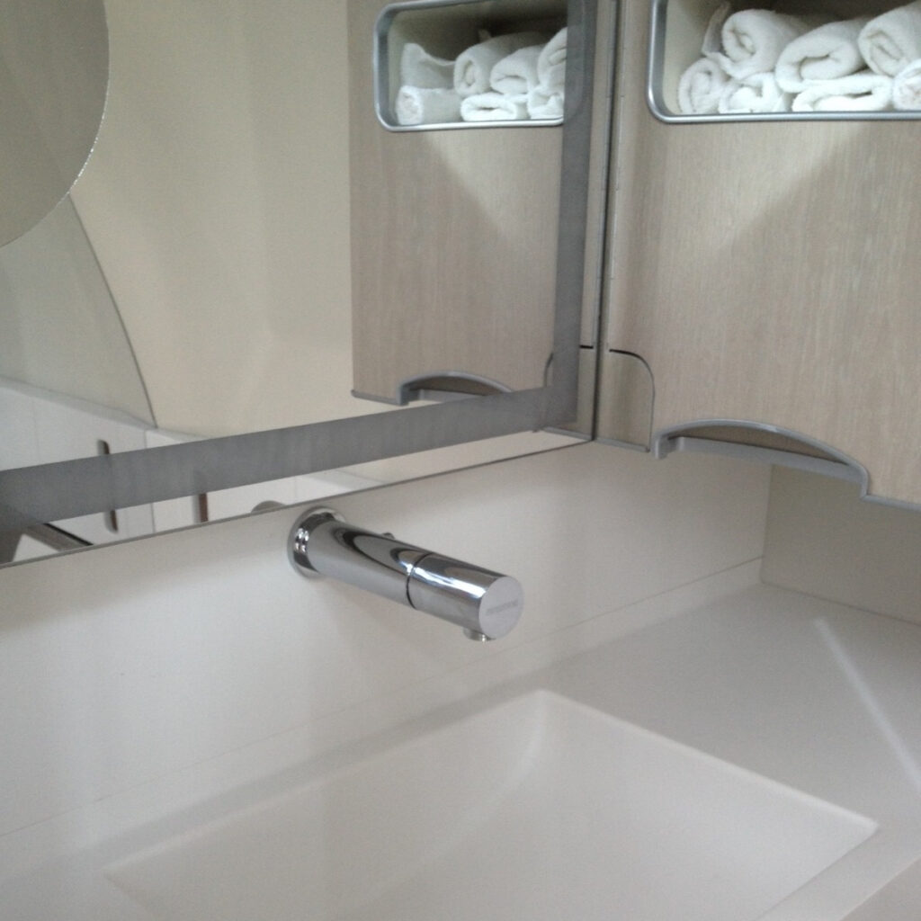 Tubular 1000 Touchless Wall Tap | Touch free electronic faucet for wall mounted installations Air France Tubular 1000B installed Touchless Faucets - Wall Mounted Bathroom Faucet - Touch free electronic faucet for wall mounted installations Air France - Tubular 1000B installed